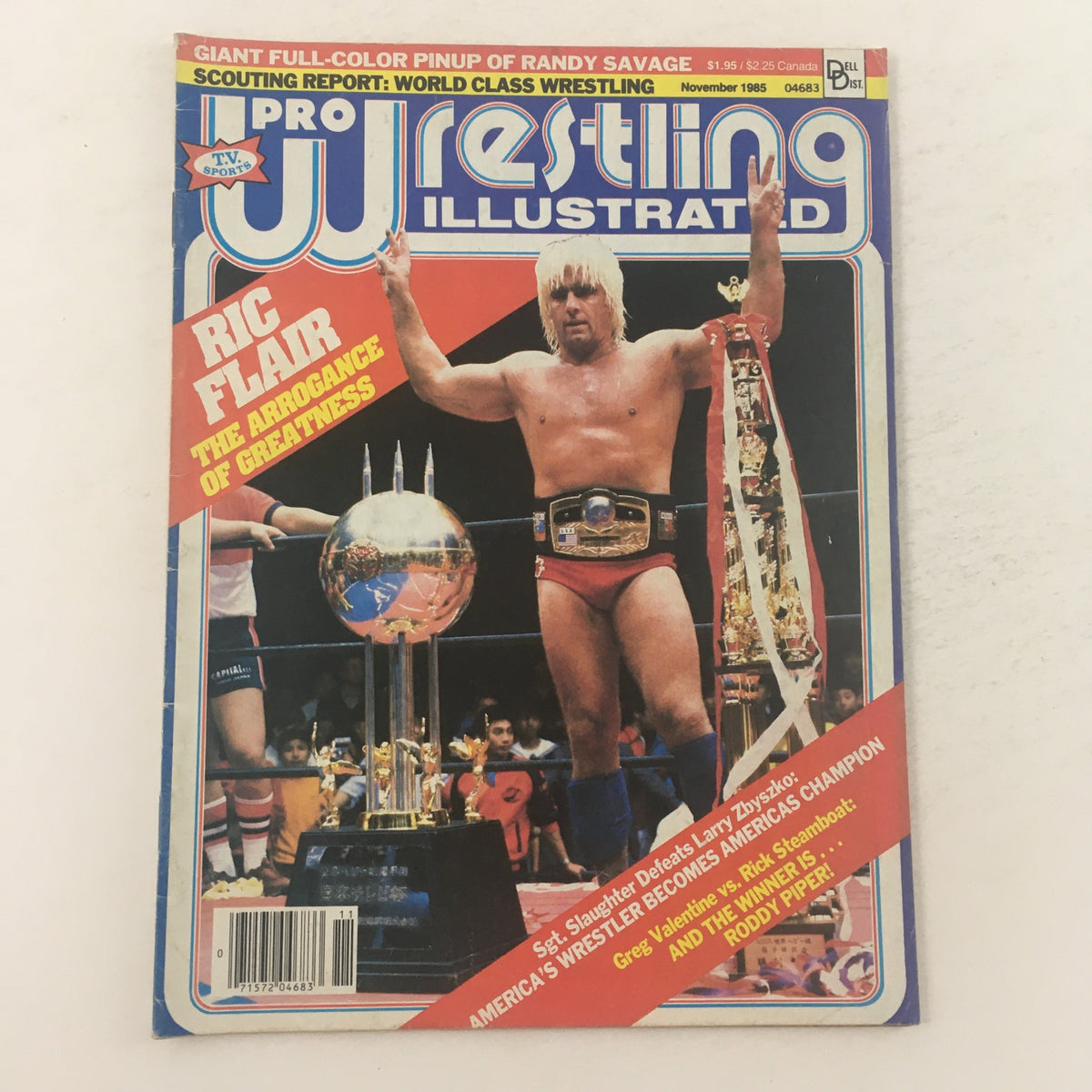 Pro Wrestling Illustrated November 1985 cover featuring Ric Flair, showcasing his title as 'The Arrogance of Greatness' with a trophy in the wrestling ring.