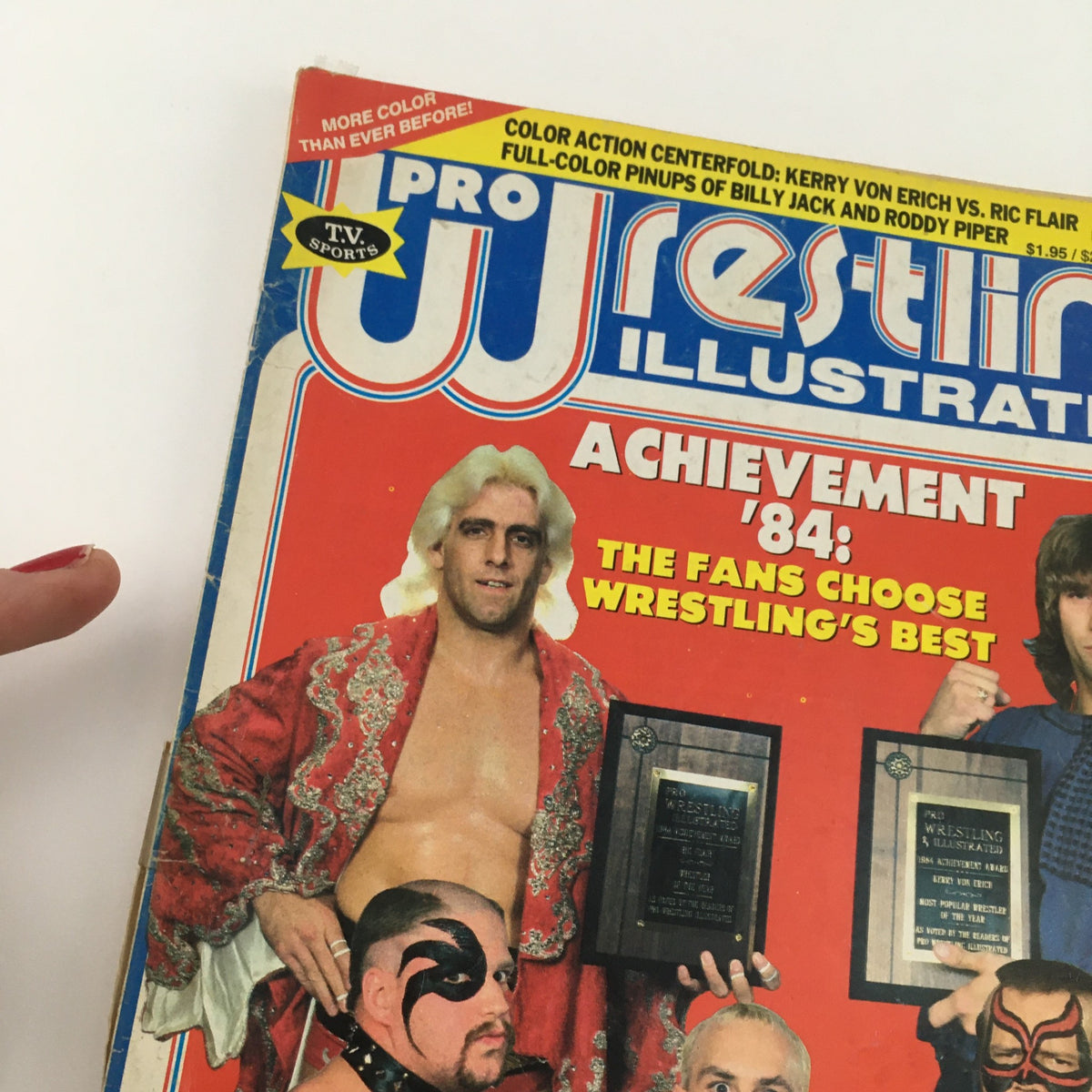 Close-up view of the Pro Wrestling Illustrated Magazine March 1985 cover featuring Ric Flair and wrestling awards, highlighting the fans' choice for wrestling's best.