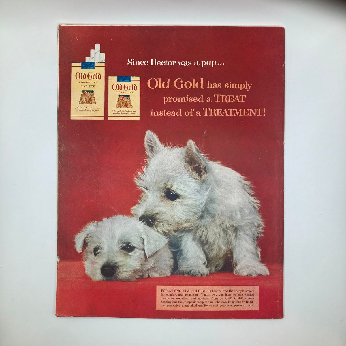 Back cover of the Saturday Evening Post Magazine April 24, 1954 showcasing an advertisement for Old Gold Cigarettes with two puppies.