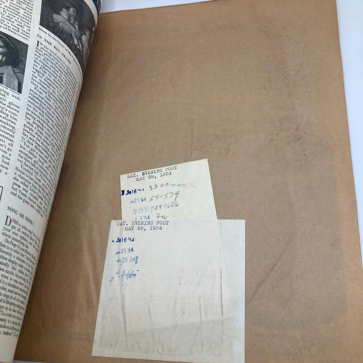 Folded page of Saturday Evening Post Magazine May 29 1954 with annotations and stamps, indicating its archival status.