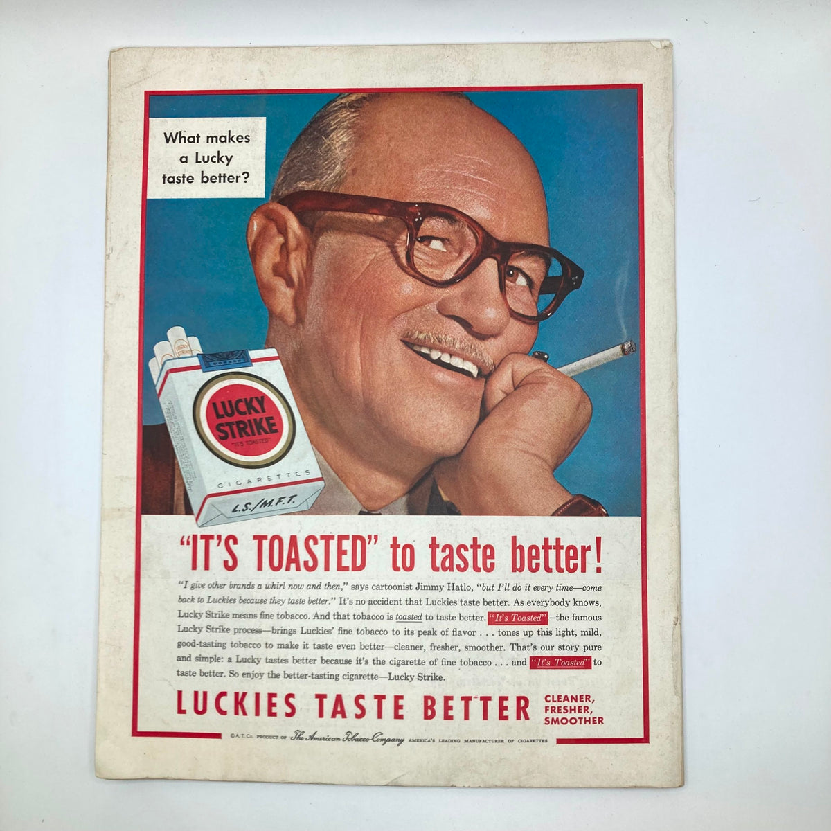 Advertisement from the Saturday Evening Post Magazine July 24, 1954 promoting Lucky Strike cigarettes, featuring a smiling man with a cigarette, representing vintage marketing.
