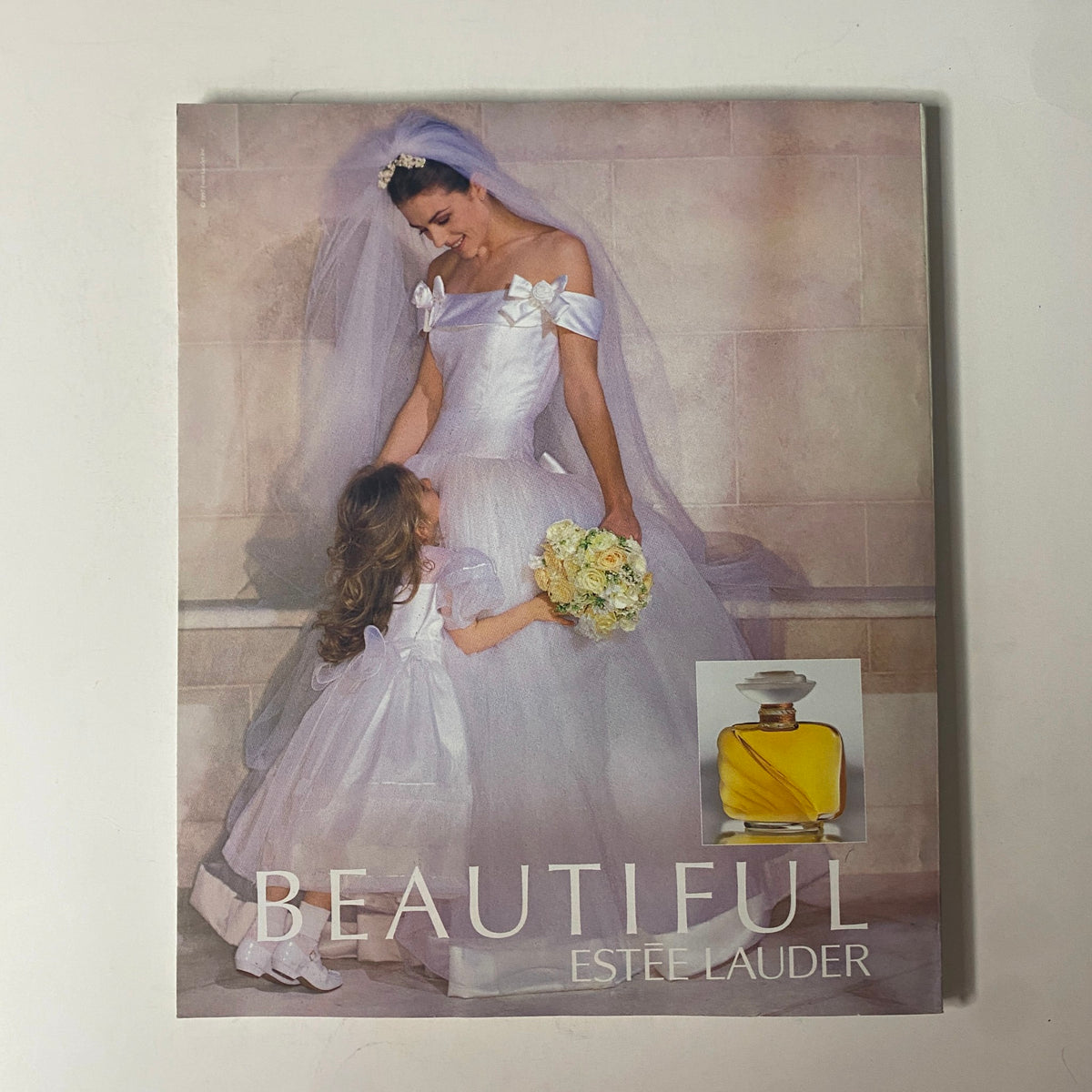 Cover of the Beautiful Estee Lauder brochure featuring a bride and flower girl in elegant attire.