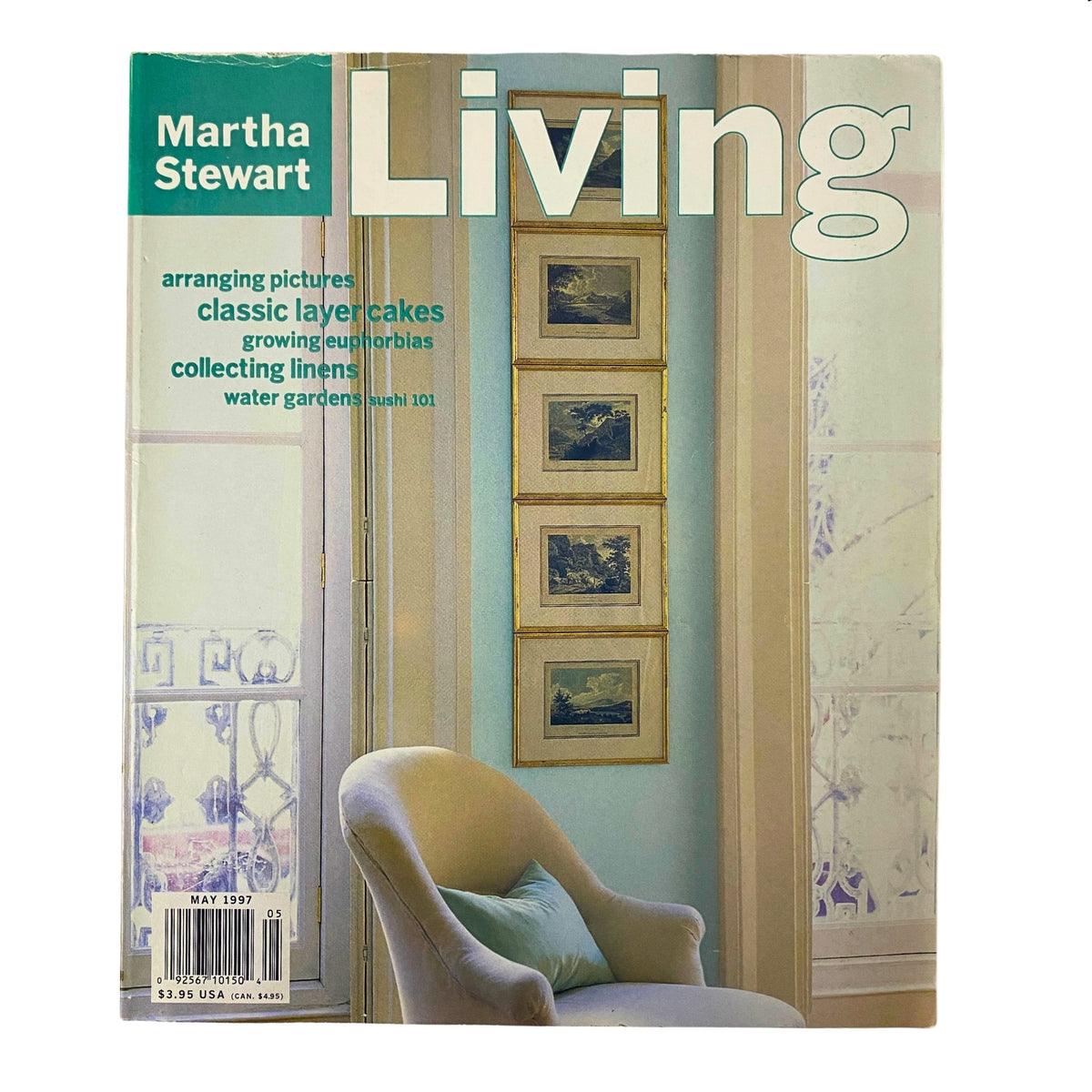 Cover of Martha Stewart Living Magazine May 1997 featuring classic layer cakes, with articles on arranging pictures, growing euphorbias, and collecting linens.