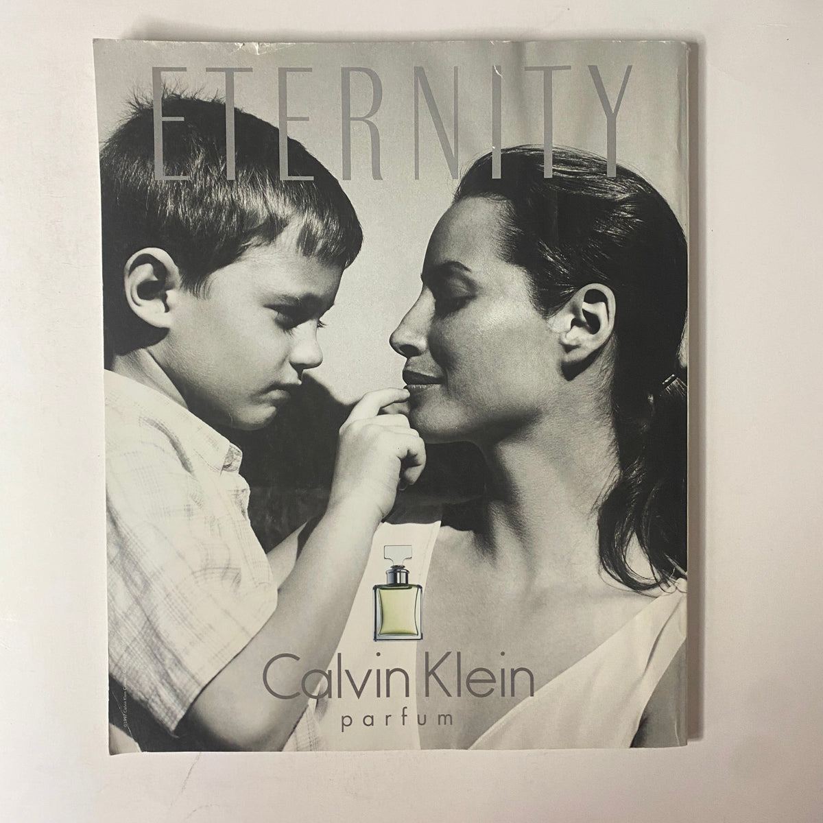 Promotional page for Calvin Klein Eternity perfume featuring a black and white image of a mother and child, emphasizing themes of love and family.
