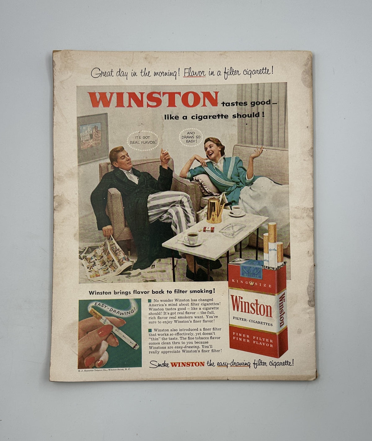 Vintage advertisement from Photoplay Magazine May 1955 featuring a Winston cigarette promotion with a man and woman in casual attire, emphasizing the flavor and smoothness of Winston cigarettes.