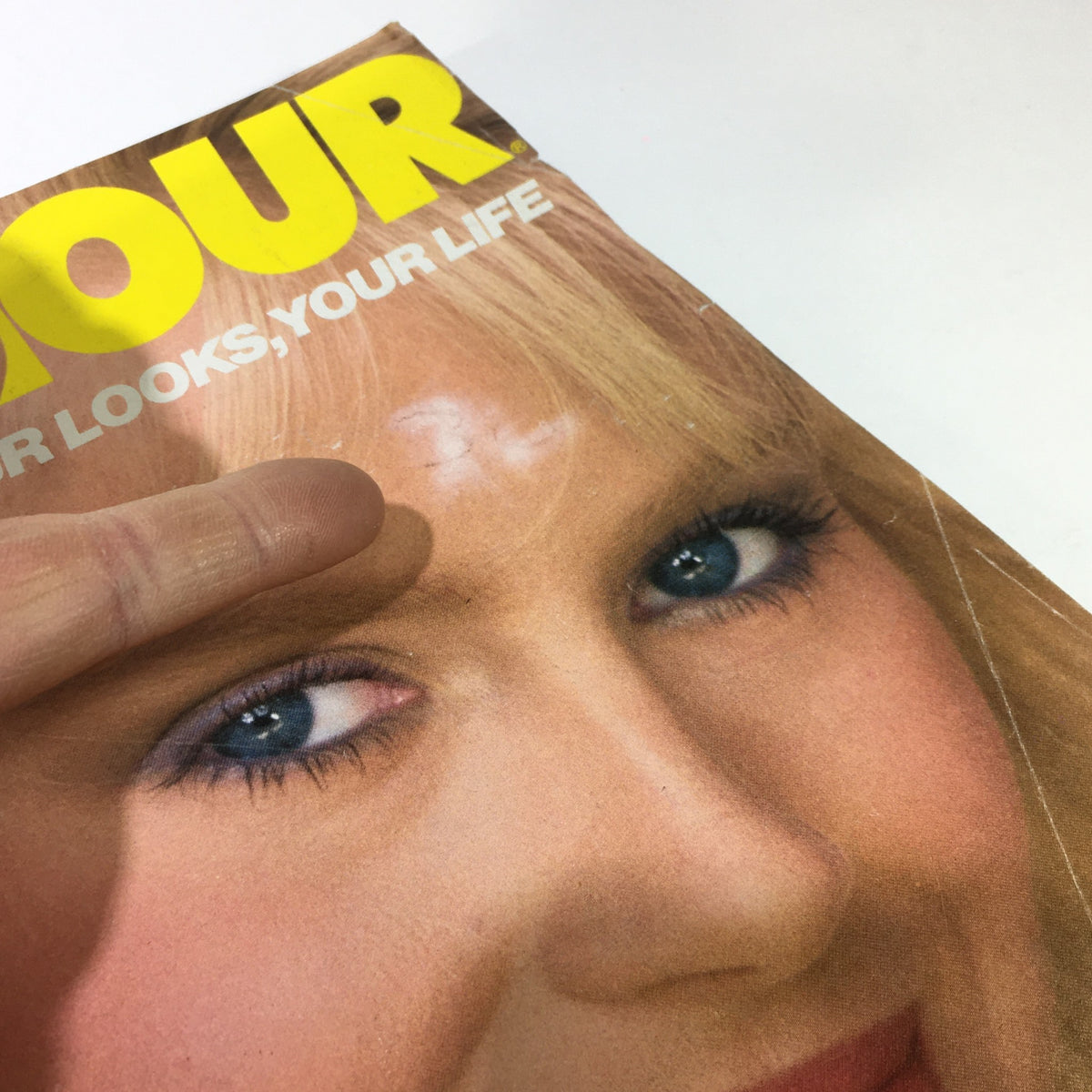 Close-up of the VTG Glamour Magazine: February 1983 cover highlighting Bitten Knudsen's face, showing visible wear and tear details.
