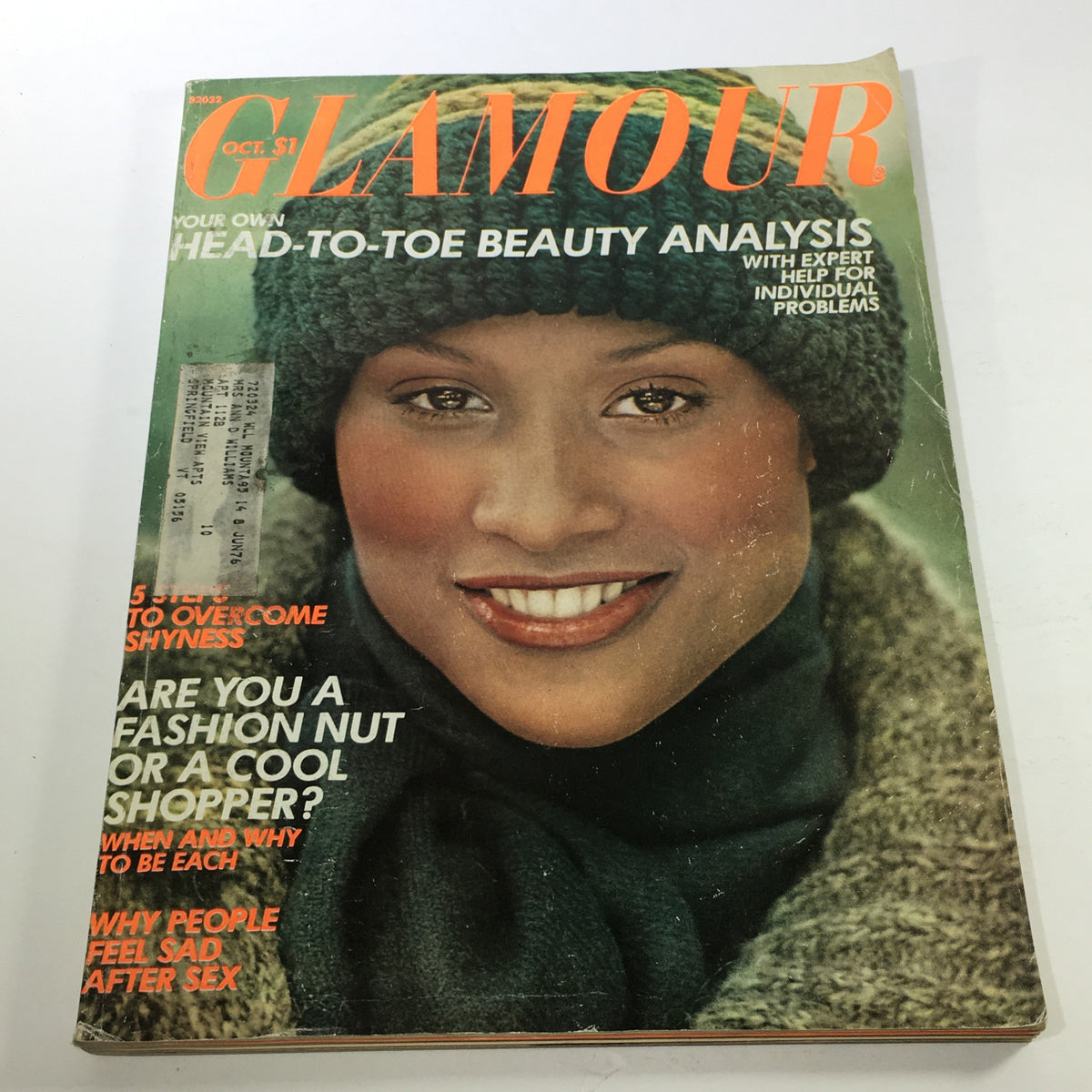 VTG Glamour Magazine: October 1975 featuring a model on the cover, wearing a knitted green hat and scarf, showcasing fashion trends of the 1970s.