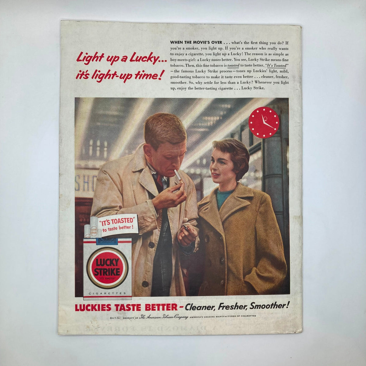 Advertisement page from the Saturday Evening Post Magazine April 2 1955 showcasing Lucky Strike cigarette promotion with a vintage couple in a nostalgic setting.