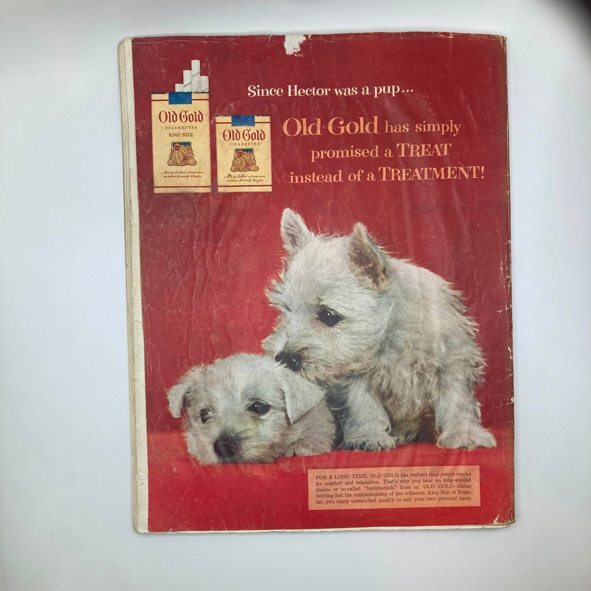 Back cover of Saturday Evening Post Magazine April 24 1954 featuring an advertisement for Old Gold cigarettes with two adorable puppies.