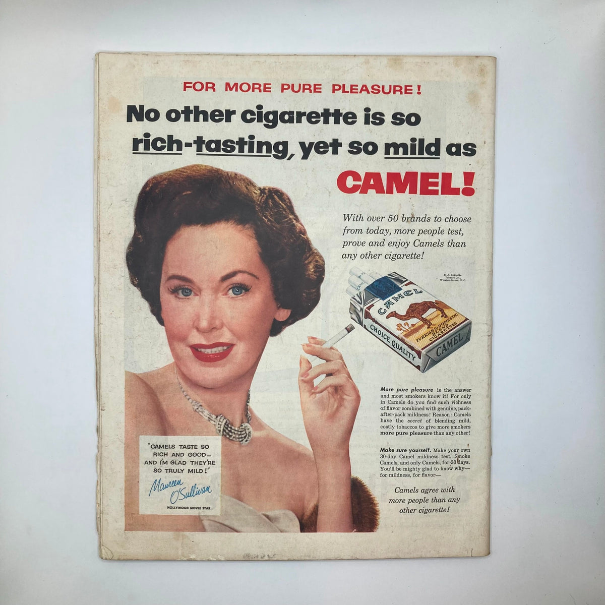 Back cover of Saturday Evening Post Magazine November 13, 1954, featuring a vintage advertisement for Camel cigarettes with a glamorous woman promoting the brand, reflecting 1950s American advertising style.