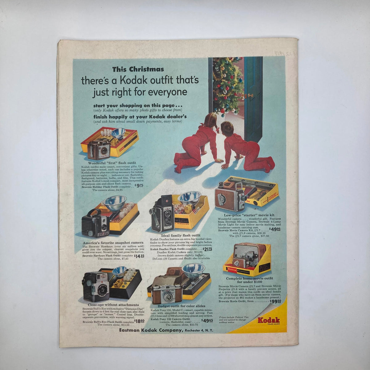 Advertisement page from Saturday Evening Post Magazine December 17, 1955 featuring Kodak camera products with children in red pajamas and a Christmas tree.