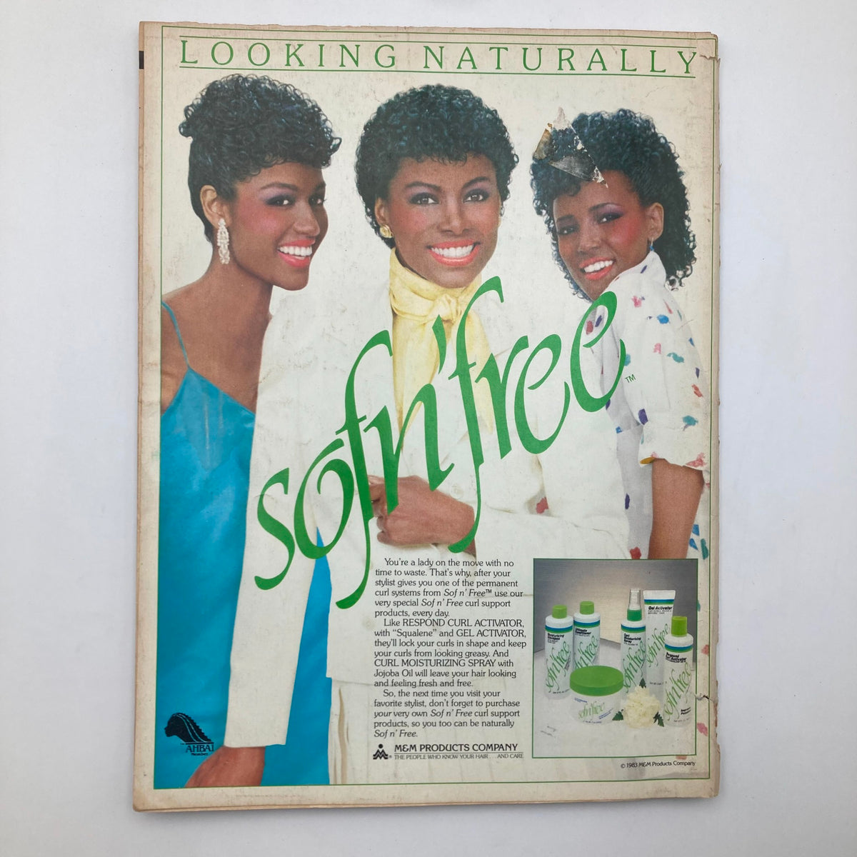 Advertisement page from June 1984 Essence Magazine promoting Sofn'Free products, featuring three models showcasing beautiful hairstyles.