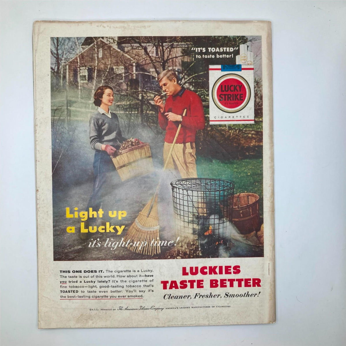 Back cover of the Saturday Evening Post Magazine November 10, 1956, featuring a vintage advertisement for Lucky Strike cigarettes, highlighting an outdoor scene with two individuals.