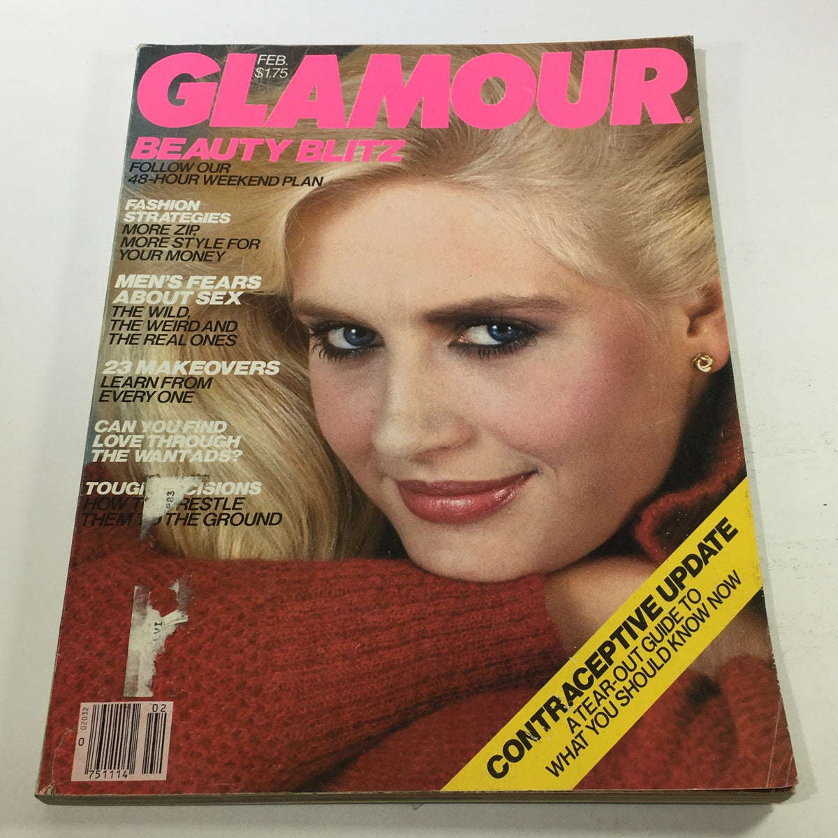 Cover of VTG Glamour Magazine from February 1982 featuring a model with blonde hair and striking makeup, highlighting the issue's title, 'Glamour,' along with topics like beauty tips, makeovers, and lifestyle advice.
