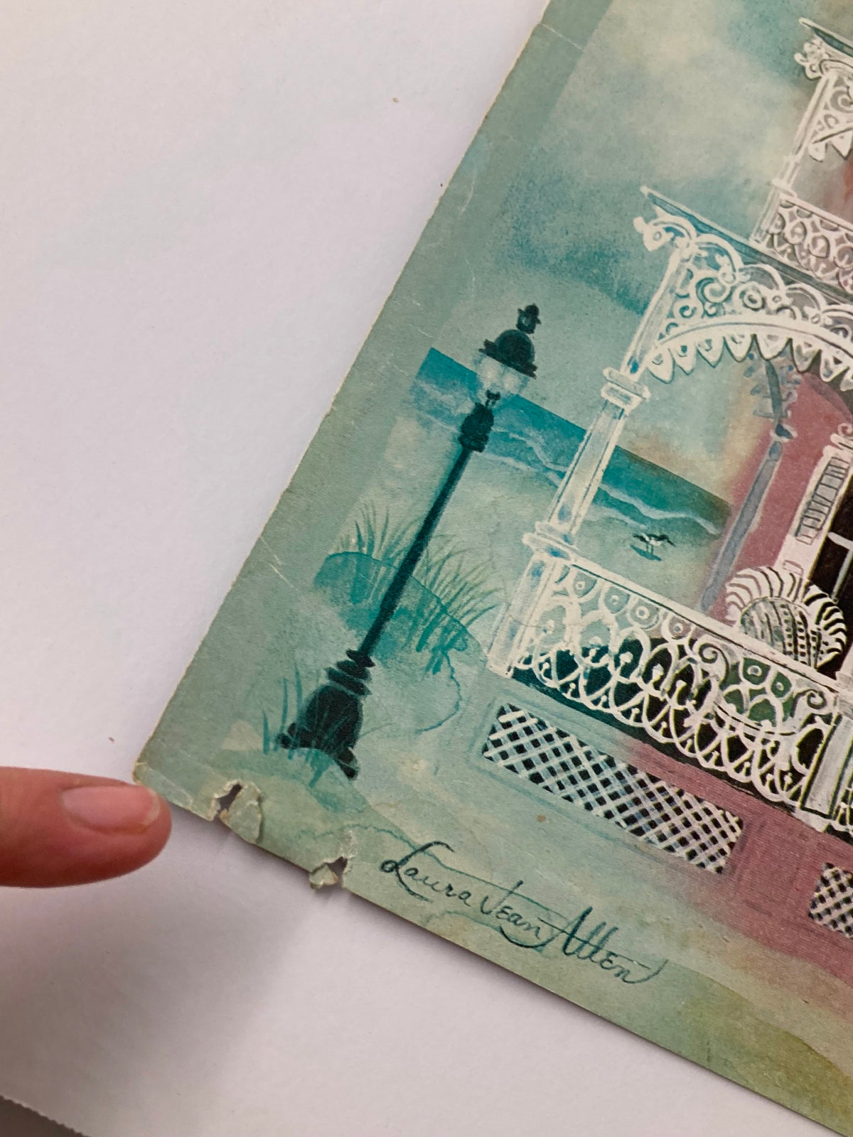 Close-up of the corner of The New Yorker cover from March 25, 1974, featuring the SeaView illustration by Laura Jean Allen, showcasing wear and an artist's signature.