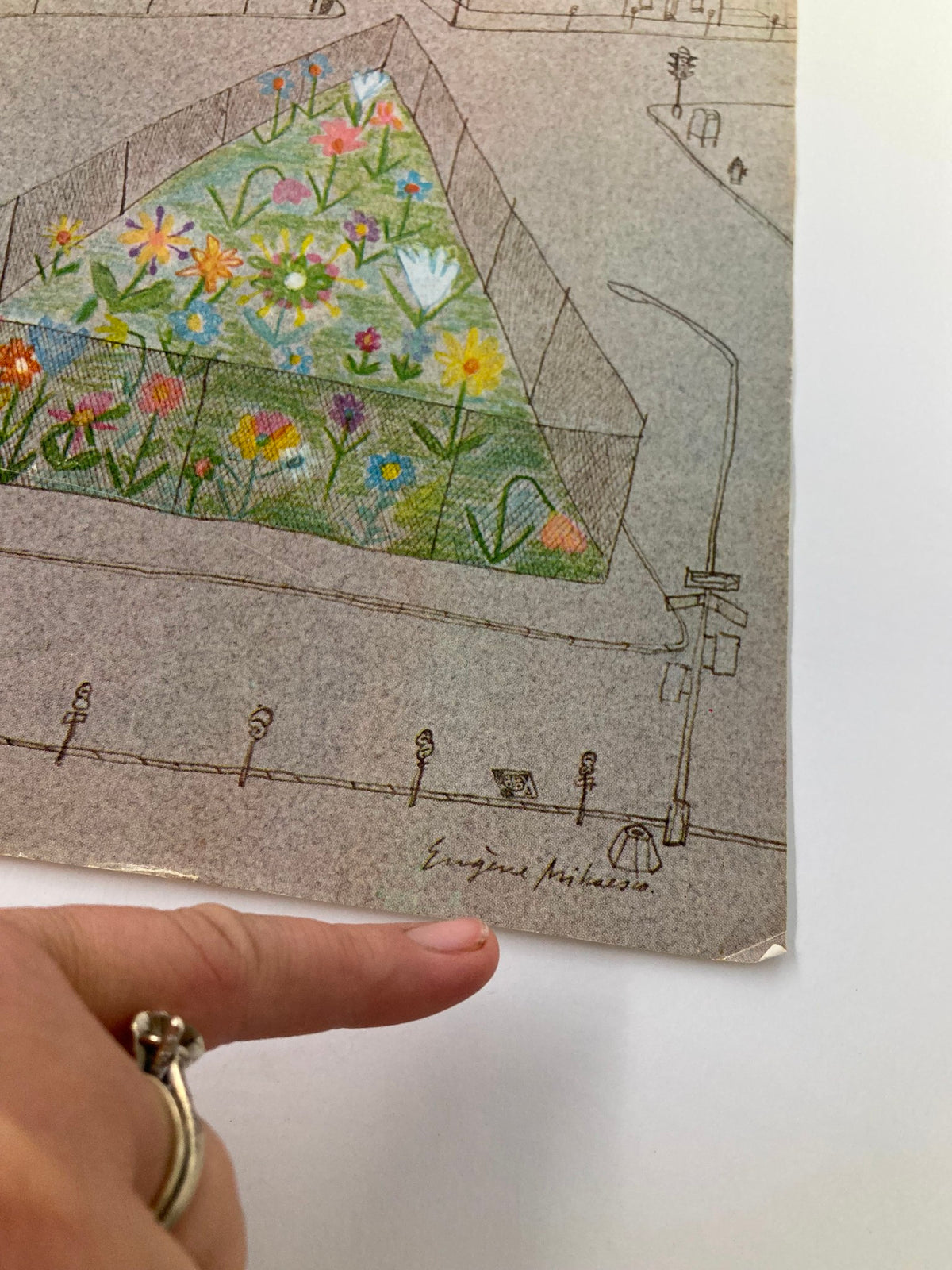 Close-up of the signature by artist E. Mihaesco on the cover of The New Yorker magazine dated August 16, 1976, featuring a vibrant street painting with flowers.