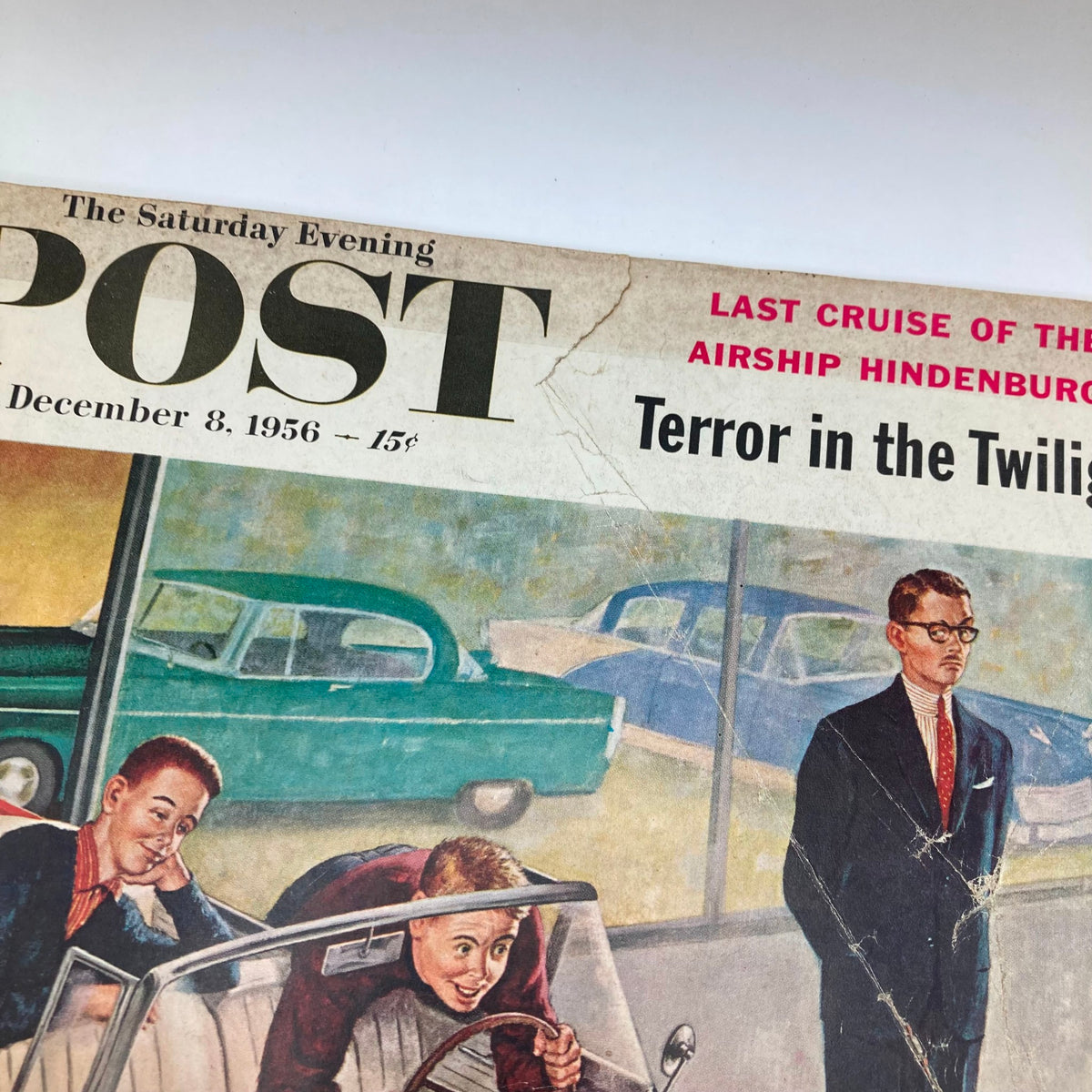Detail of the cover from Saturday Evening Post Magazine December 8 1956, highlighting the title and tagline, showcasing chic cars and the nostalgic ambiance of the 1950s.