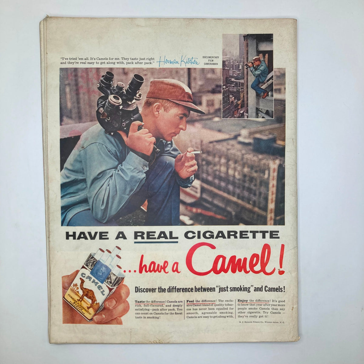 Back cover of Saturday Evening Post Magazine December 8 1956 advertising Camel cigarettes, featuring a man holding a camera and savoring the essence of mid-century life.