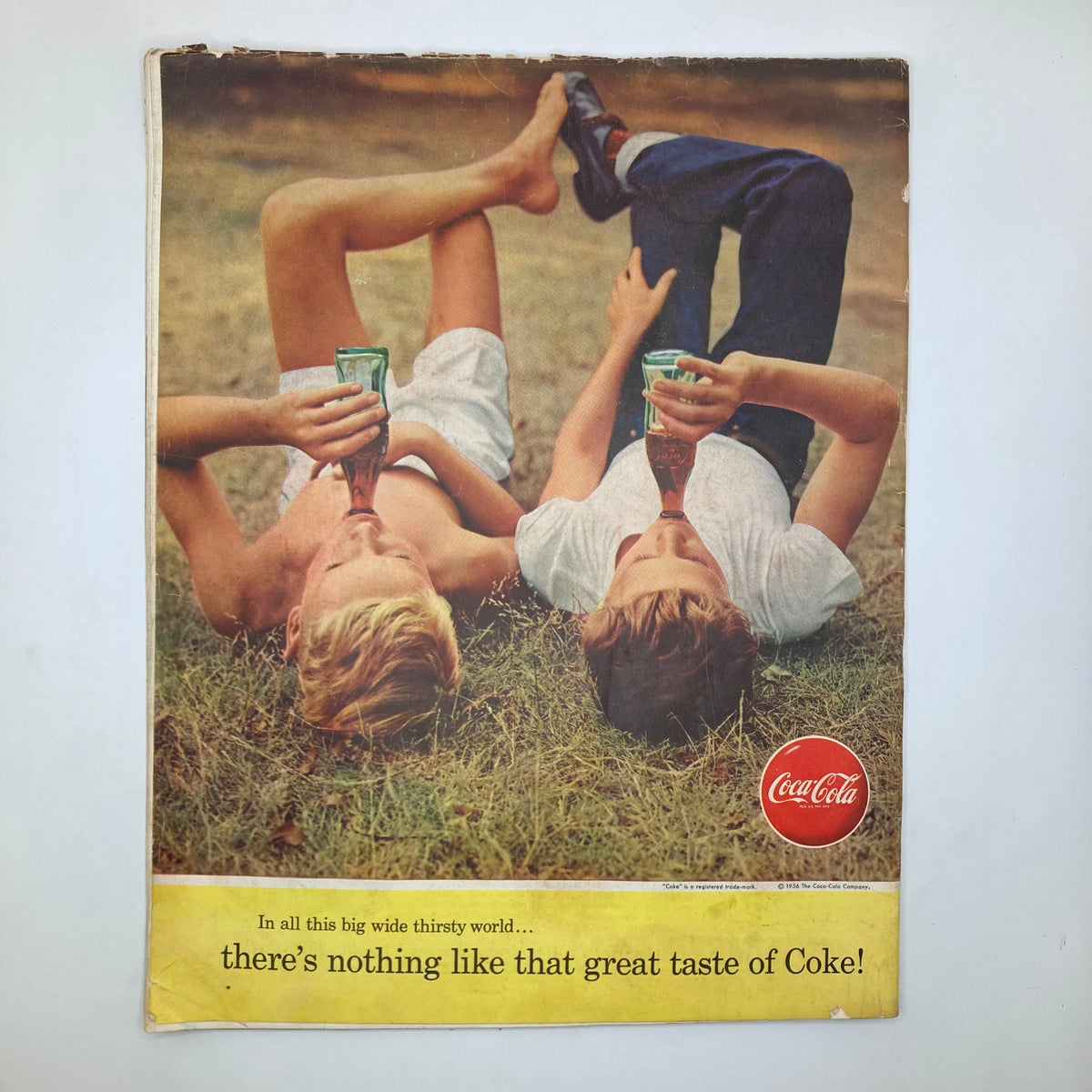 Back cover of the Saturday Evening Post Magazine July 7, 1956 showing two children lying on the grass enjoying Coca-Cola, with a vintage advertisement reflecting mid-century Americana.