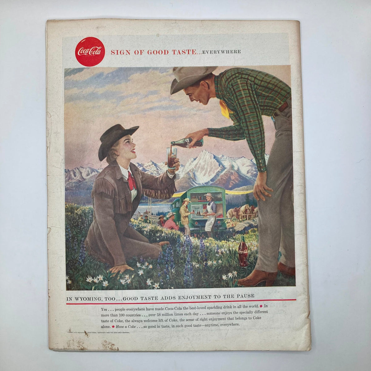 Vintage advertisement page from the Saturday Evening Post Magazine, May 10, 1958, featuring a Coca-Cola ad against a picturesque mountain backdrop.