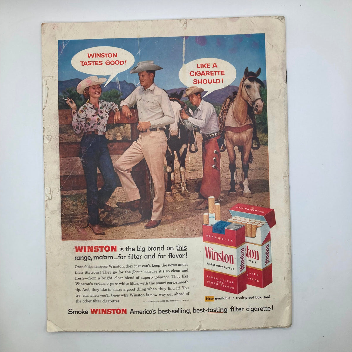 Back cover advertisement of Winston cigarettes from Saturday Evening Post Magazine April 26, 1958, depicting a western scene with cowboys and promoting cigarette flavor.