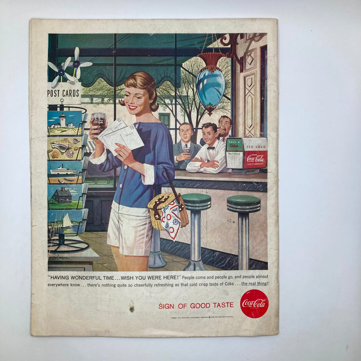 Back cover of the Saturday Evening Post Magazine dated August 2, 1958, displaying a vintage advertisement for Coca-Cola, featuring a cheerful woman and nostalgic imagery.