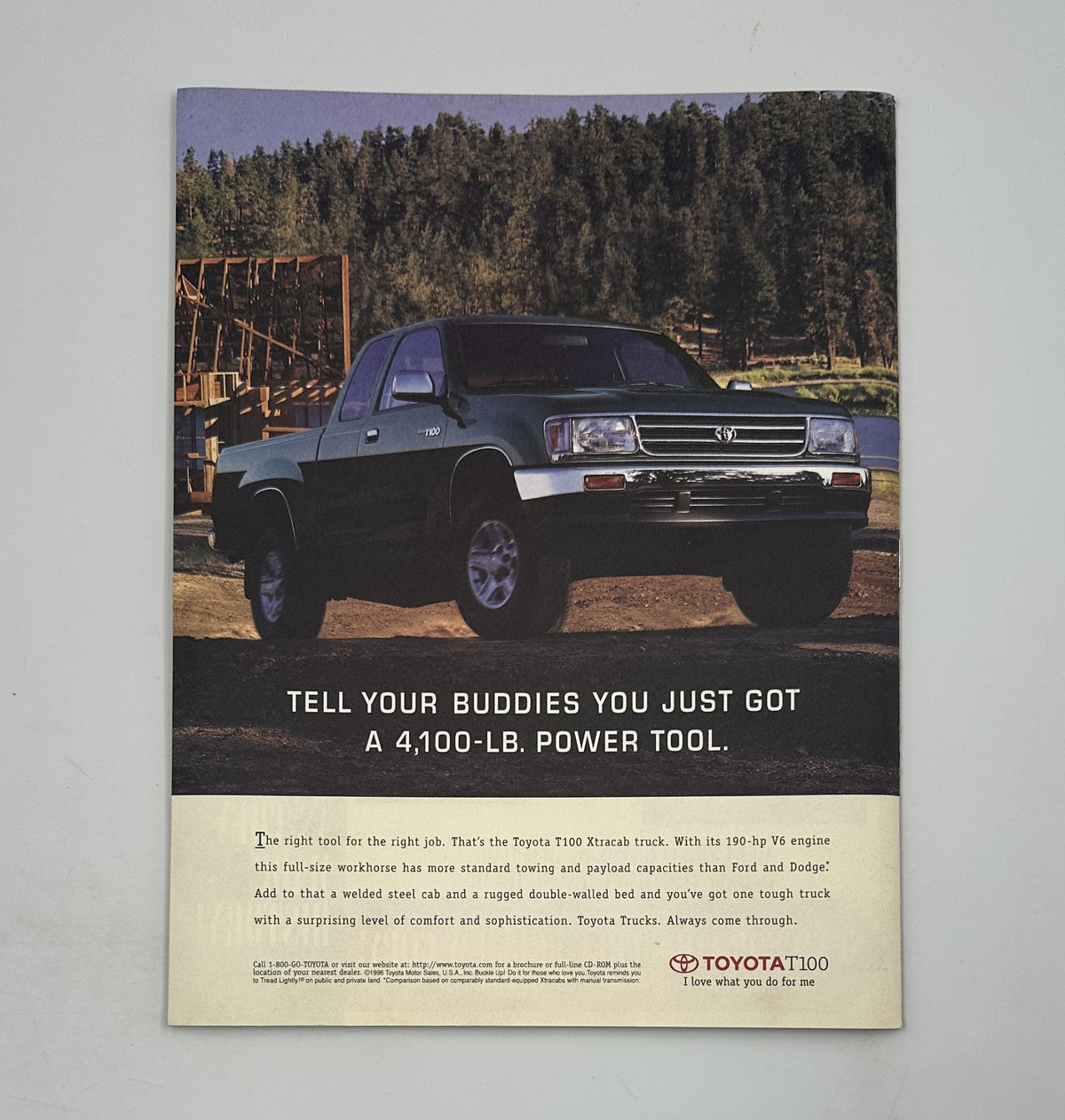 Advertisement for the Toyota T100 truck emphasizing its power and capabilities as a reliable work vehicle, featured in Time Magazine April 7, 1997. Showcases a rugged outdoor setting.