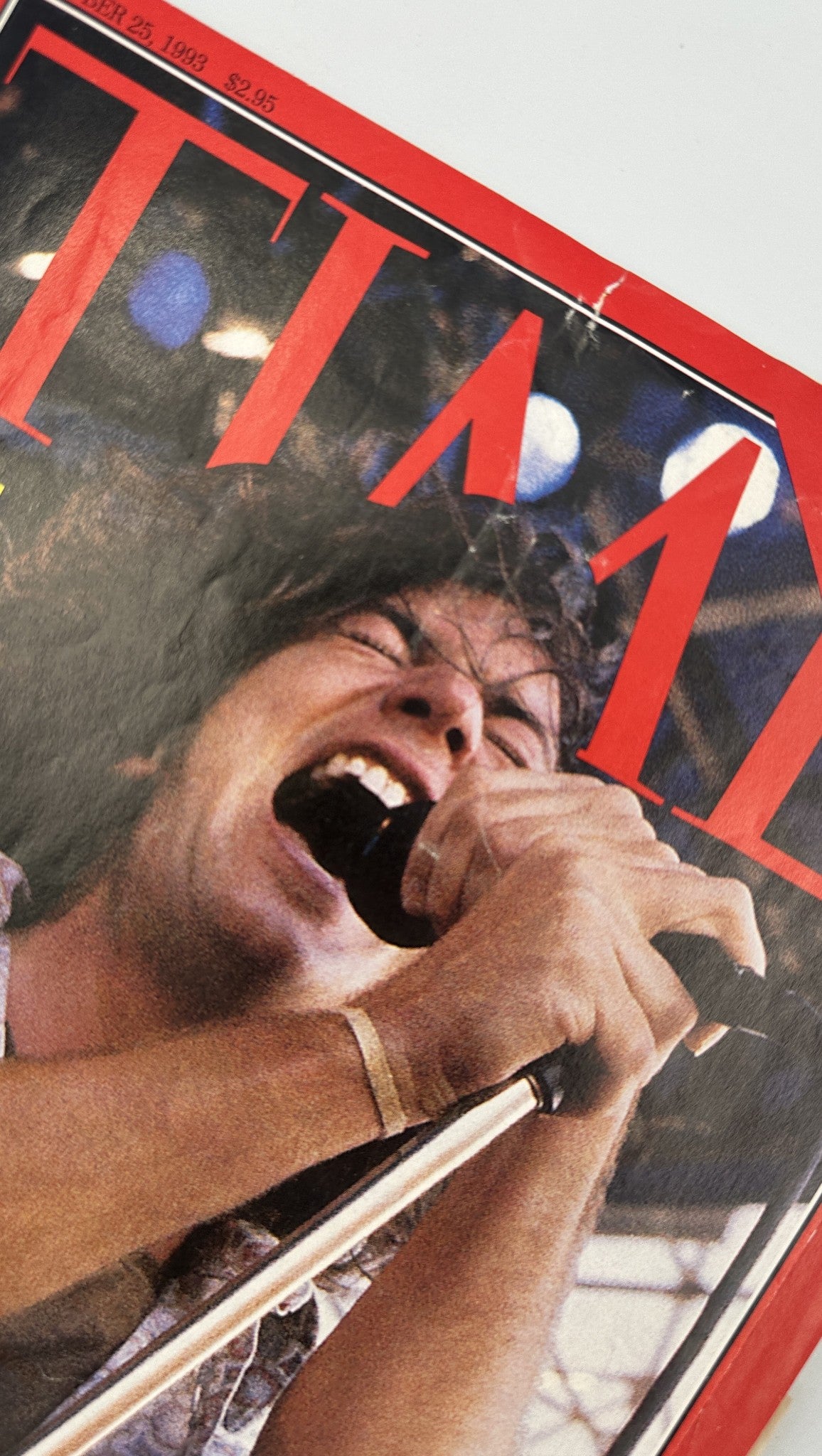 Close-up of Time Magazine cover from October 25, 1993 with a photograph of Eddie Vedder of Pearl Jam passionately singing, highlighting the rock band in the spotlight.