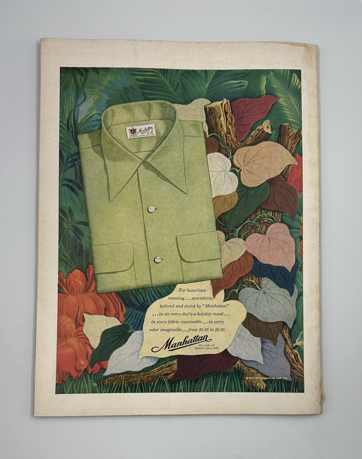 Flair Magazine June 1950 cover featuring a green shirt design from Manhattan, surrounded by vibrant foliage and flowers, showcasing art and fashion styles of the era.