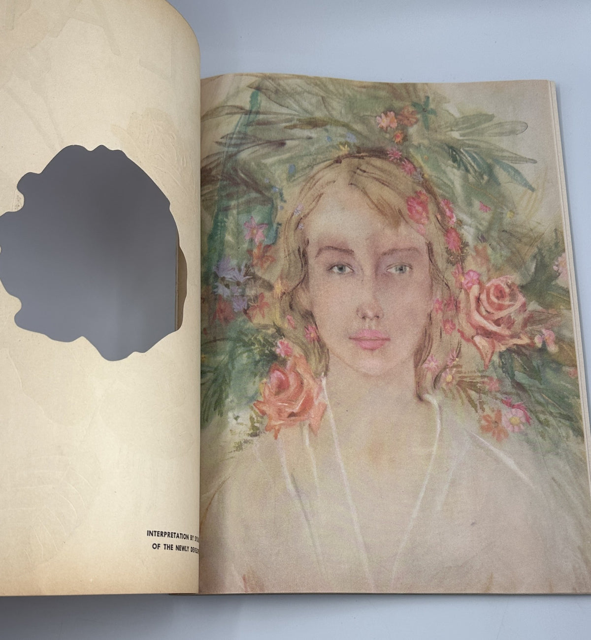 Flair Magazine May 1950 displaying an artistic portrait of a woman adorned with flowers, representing beauty in art.