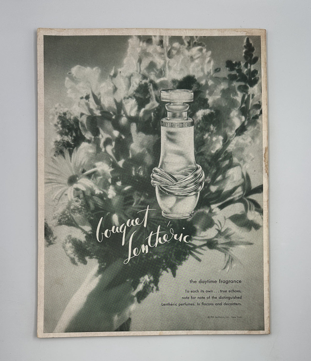 Flair Magazine July 1950 All Male Issue advertisement for Bouquet Lenthéric, a fragrance, accompanied by floral imagery emphasizing its elegance.
