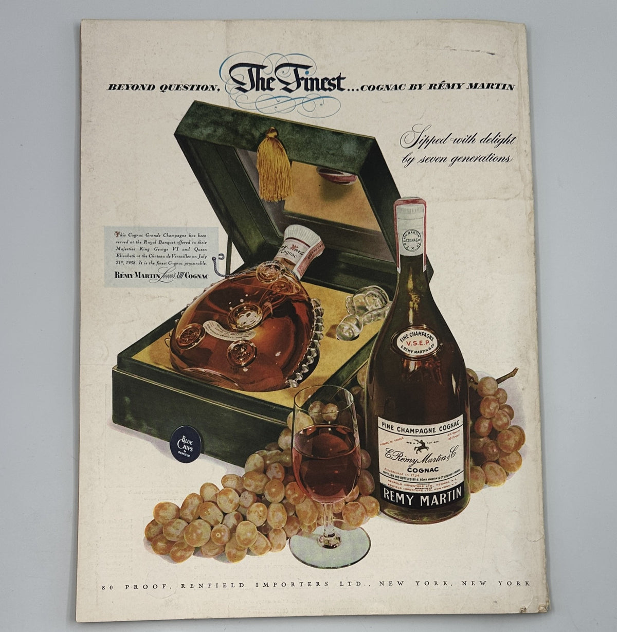 Flair Magazine November 1950 advertising page for Rémy Martin Cognac with an elegant display of the bottle and glass, emphasizing luxury.