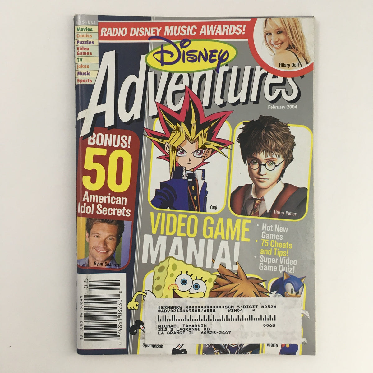 Cover of Disney Adventures Magazine February 2004 featuring pop icons Hillary Duff and Daniel Radcliffe, with special highlights on video games and American Idol secrets.