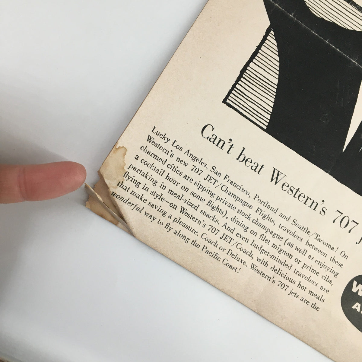 Close-up of the back cover of the March 10, 1960 NCAA Basketball UCLA vs Stanford Official Program, showing a tear and detail of the Western Airlines advertisement.