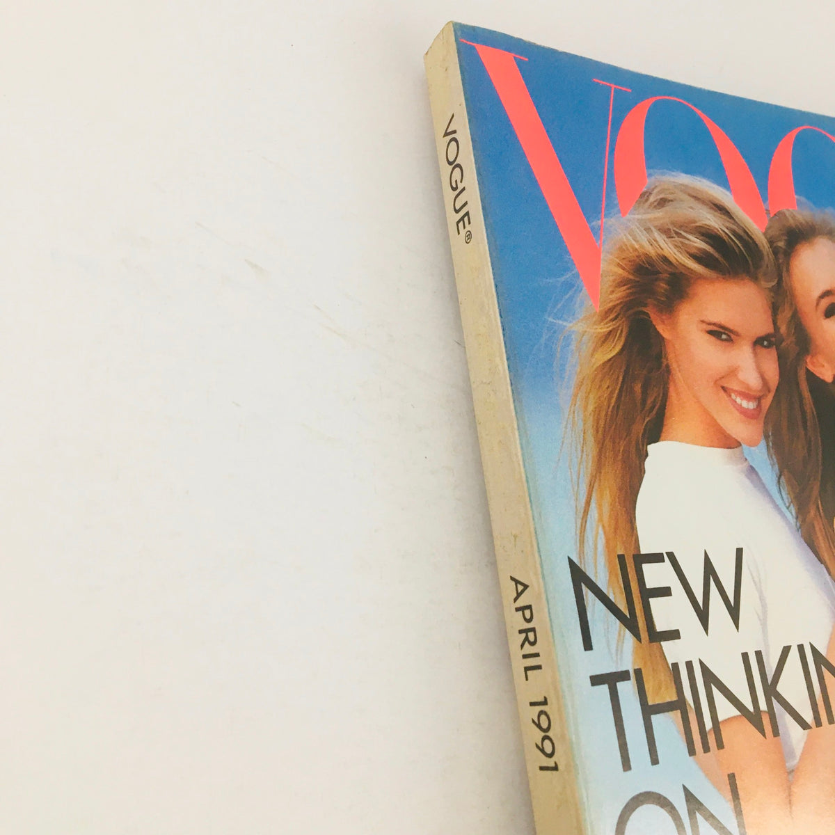 Side view of Vogue Magazine April 1991 highlighting the issue date and cover art featuring models in stylish outfits.
