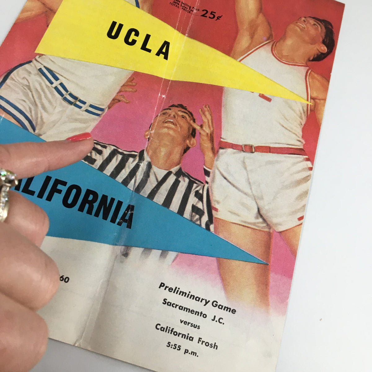 Close-up of the 1960 UCLA Bruins USC Trojans Basketball Program showing the vibrant cover art and details of the preliminary game.