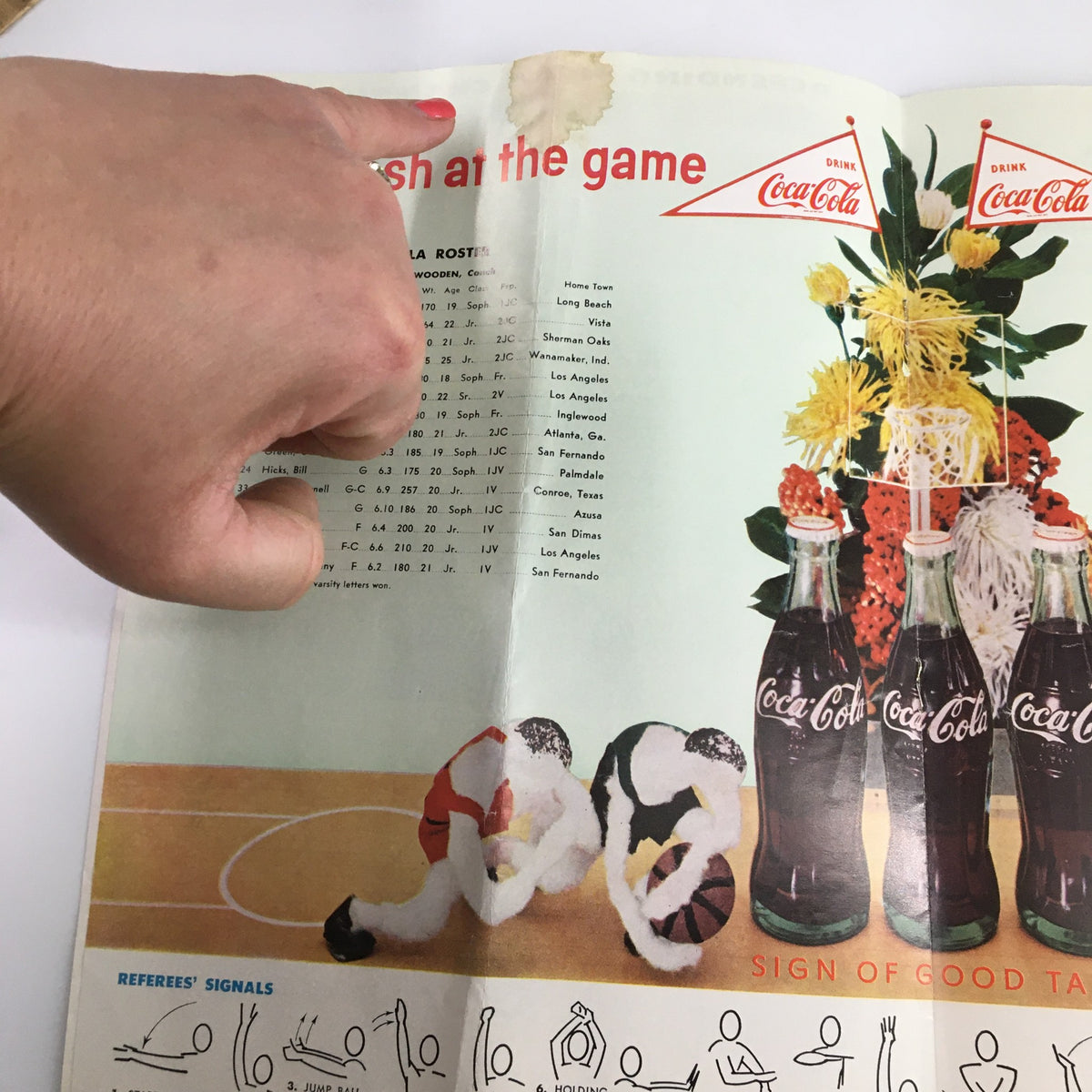 Detail of the 1960 UCLA Bruins USC Trojans Basketball Program highlighting the Coca-Cola advertisement and player roster.