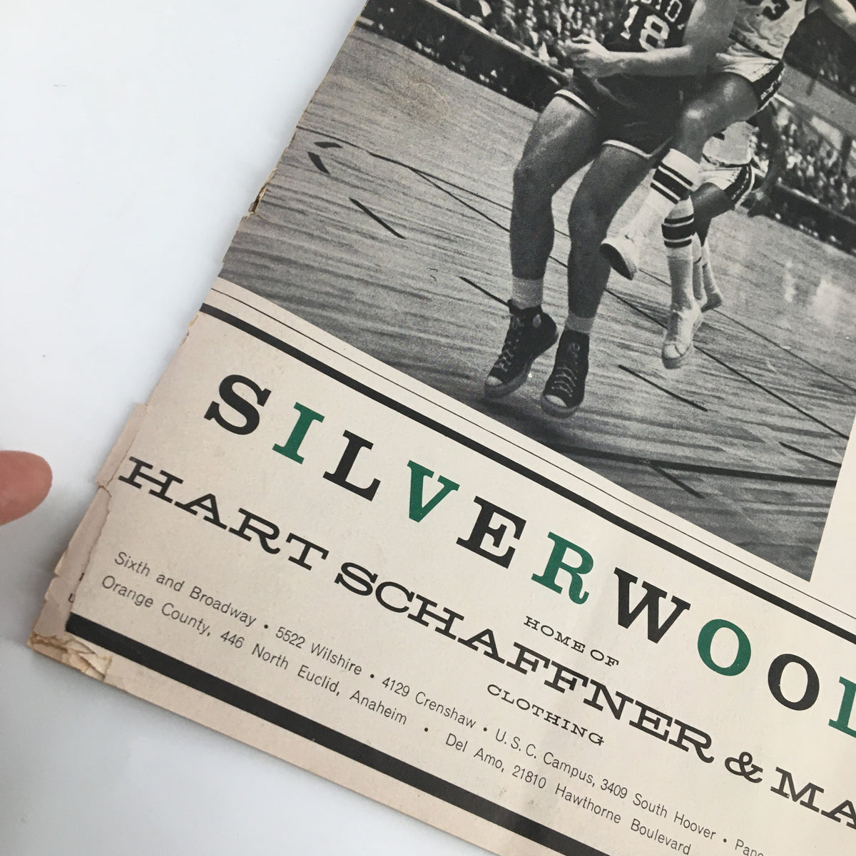 Close-up of the 1961-1962 Jim Loscutoff Rod Hundley Los Angeles Lakers Boston Game Program showing the Silverwoods advertisement, exemplifying classic vintage magazine design and basketball history.