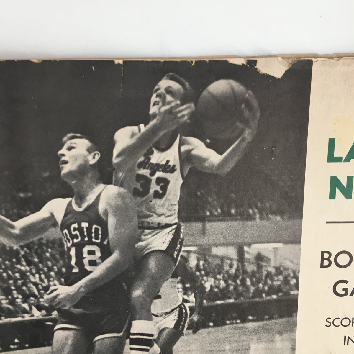 1961-1962 Jim Loscutoff Rod Hundley Los Angeles Lakers Boston Game Program featuring an intense basketball play, showcasing Loscutoff in action.