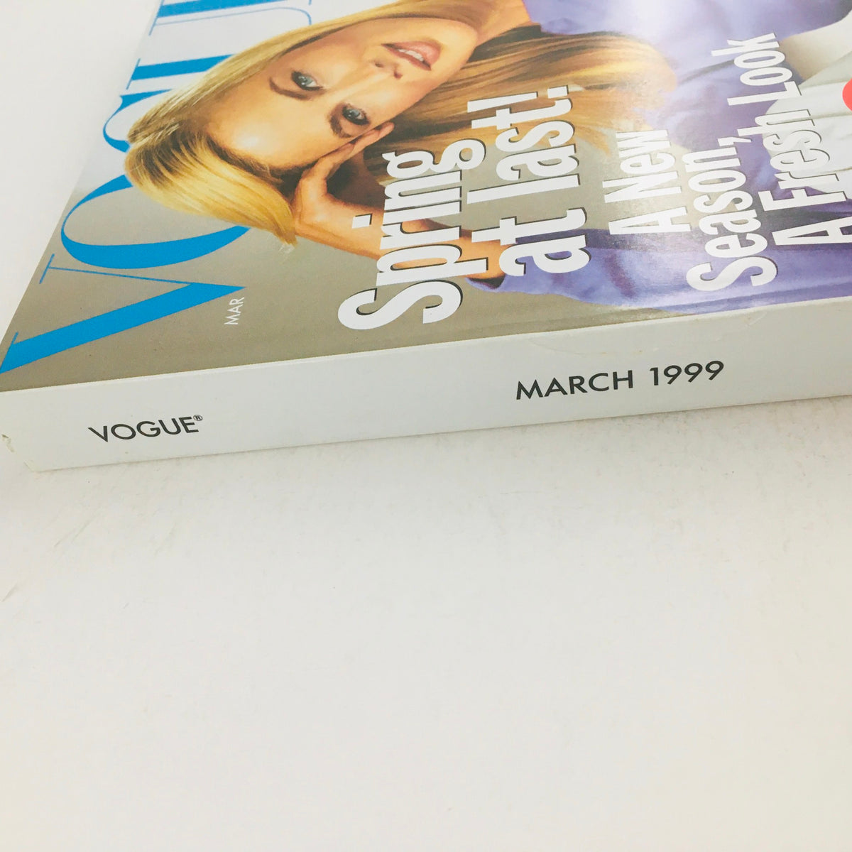Vogue Magazine March 1999 edition featuring a captivating cover and spine, showcasing the words 'Spring at last!', highlighting the arrival of a new season with a fresh look.