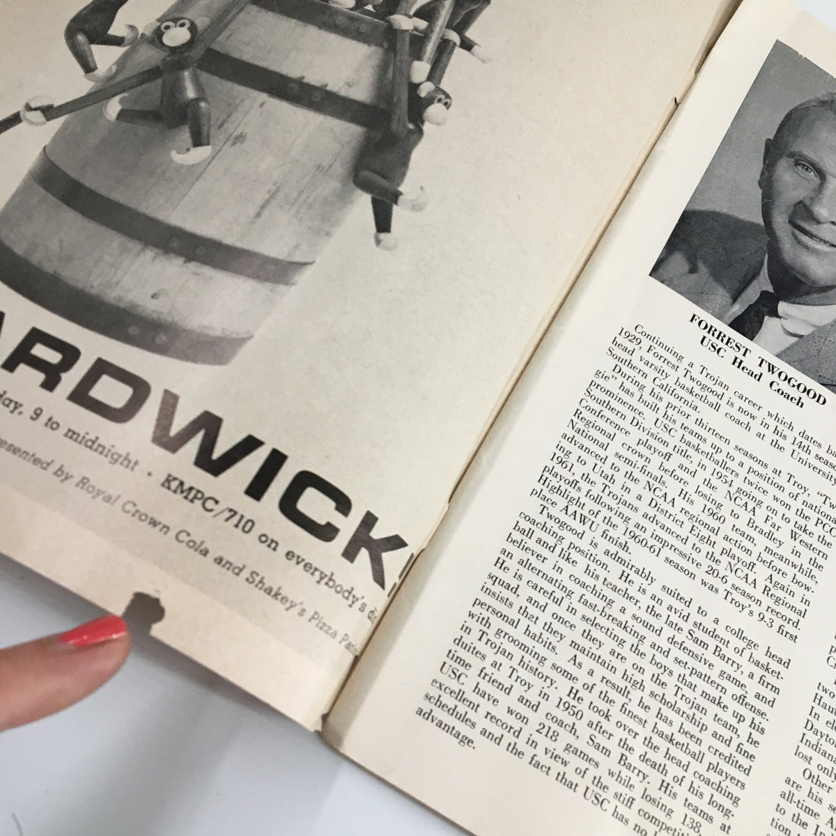 Interior page from the January 10, 1964 NCAA Basketball USC vs UCLA official program, displaying an advertisement for a local business and a profile of USC head coach Forrest Twogood.