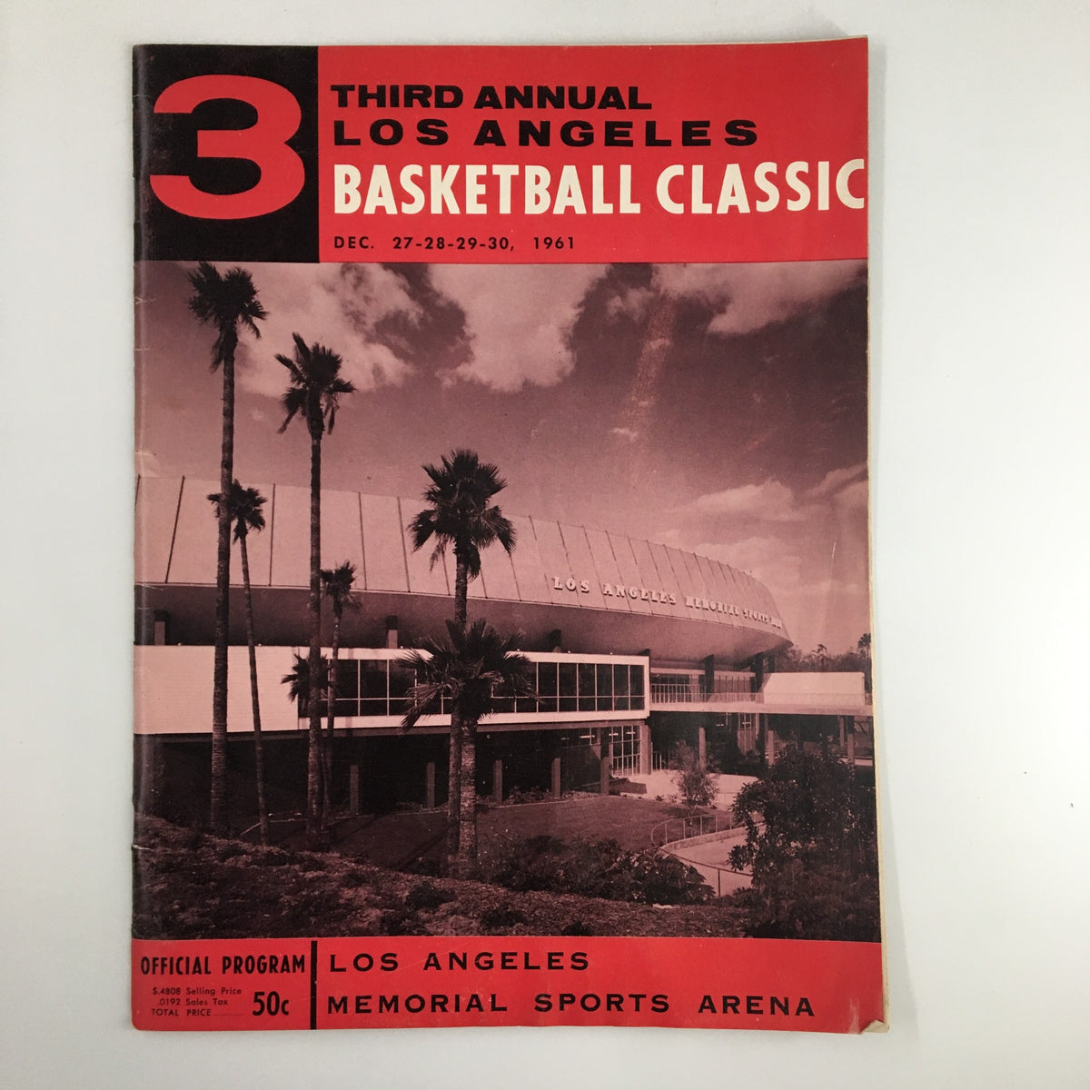 Official program cover for the December 27, 1961 NCAA UCLA vs Army Basketball Classic, featuring a photograph of the Los Angeles Memorial Sports Arena with palm trees and classic design elements, highlighting the event's significance in college basketball history.