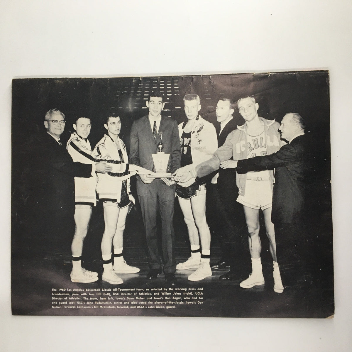 Historical photo of the 1961 Los Angeles Basketball Classic awards ceremony, featuring NCAA coaches and players in relation to the UCLA vs Army Basketball Classic.
