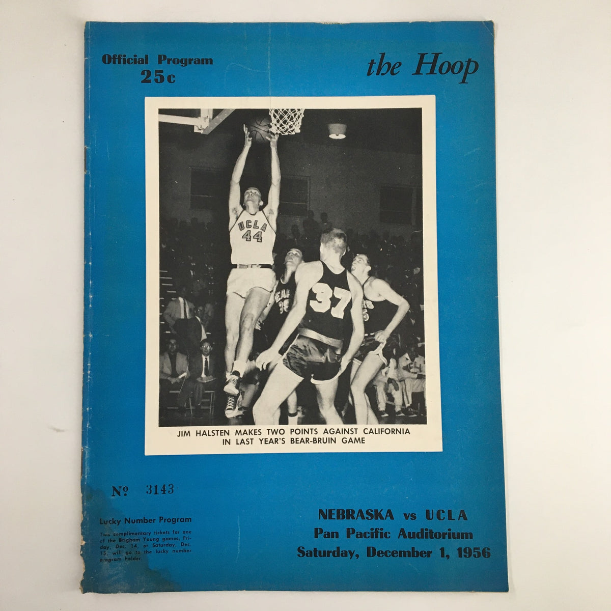 Official program cover from December 1, 1956 NCAA Basketball game Nebraska vs UCLA. Features black and white image of player Jim Hasten making a shot, with blue background and text.