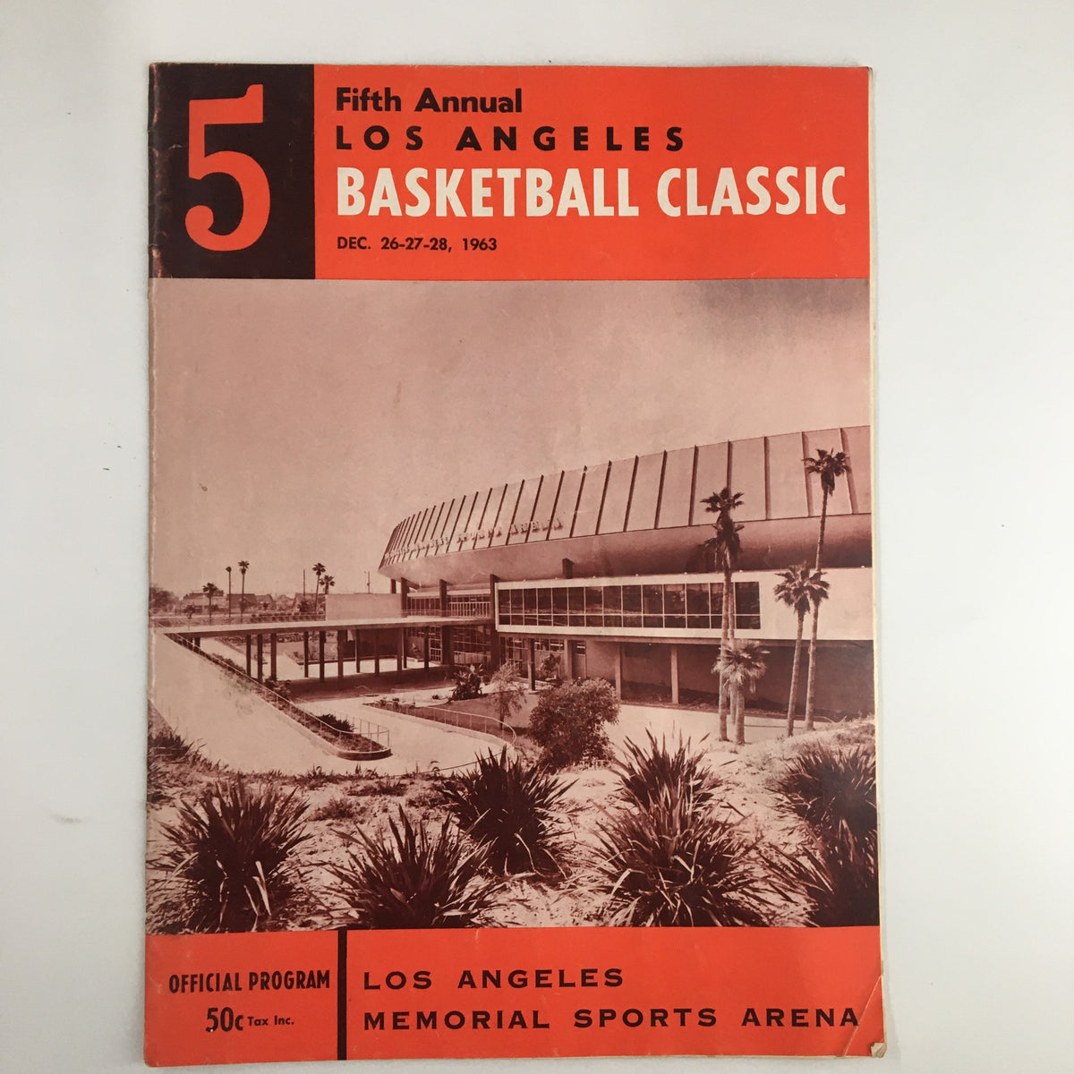Official program cover for the December 26, 1963 NCAA UCLA vs Utah State Basketball Classic, featuring the Los Angeles Memorial Sports Arena with design elements highlighting the vintage basketball event.