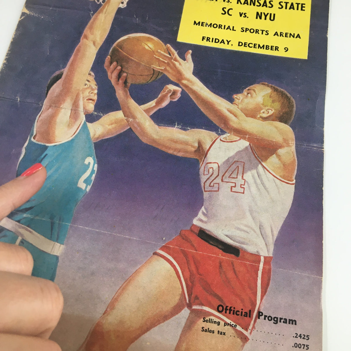 Close-up of the official program cover for the December 9, 1954 NCAA Basketball game between UCLA and Kansas State, highlighting the details of the players and game information.