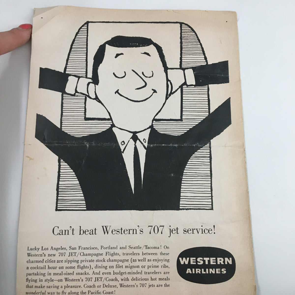 Advertisement for Western Airlines featuring an illustration of a satisfied passenger enjoying the comfort of a 707 jet flight, in the context of the December 9 1954 NCAA Basketball game.