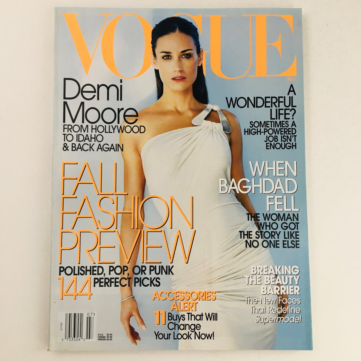 Vogue Magazine cover from July 2003 featuring American actress Demi Moore in a white dress. The magazine highlights a Fall Fashion Preview and discusses various topics including the beauty barrier and breaking fashion norms. Excellent condition with minor wear, comes with protective covering.