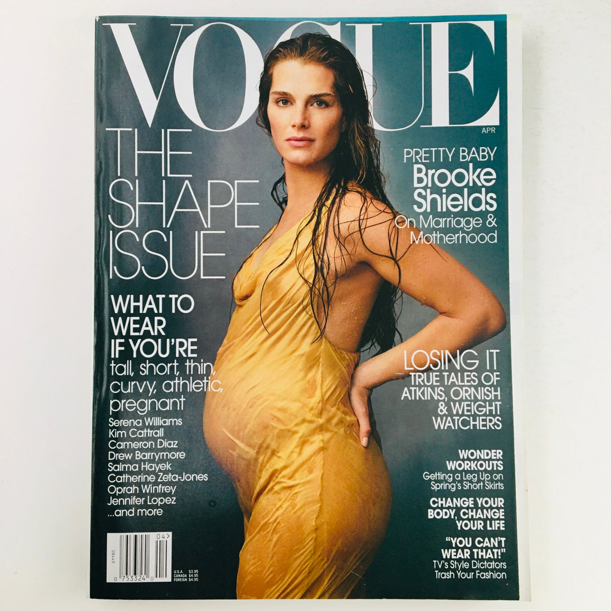 Vogue Magazine April 2003 cover featuring American actress Brooke Shields, showcasing The Shape Issue with an elegant photograph of Brooke in a yellow dress, emphasizing themes of motherhood and style.