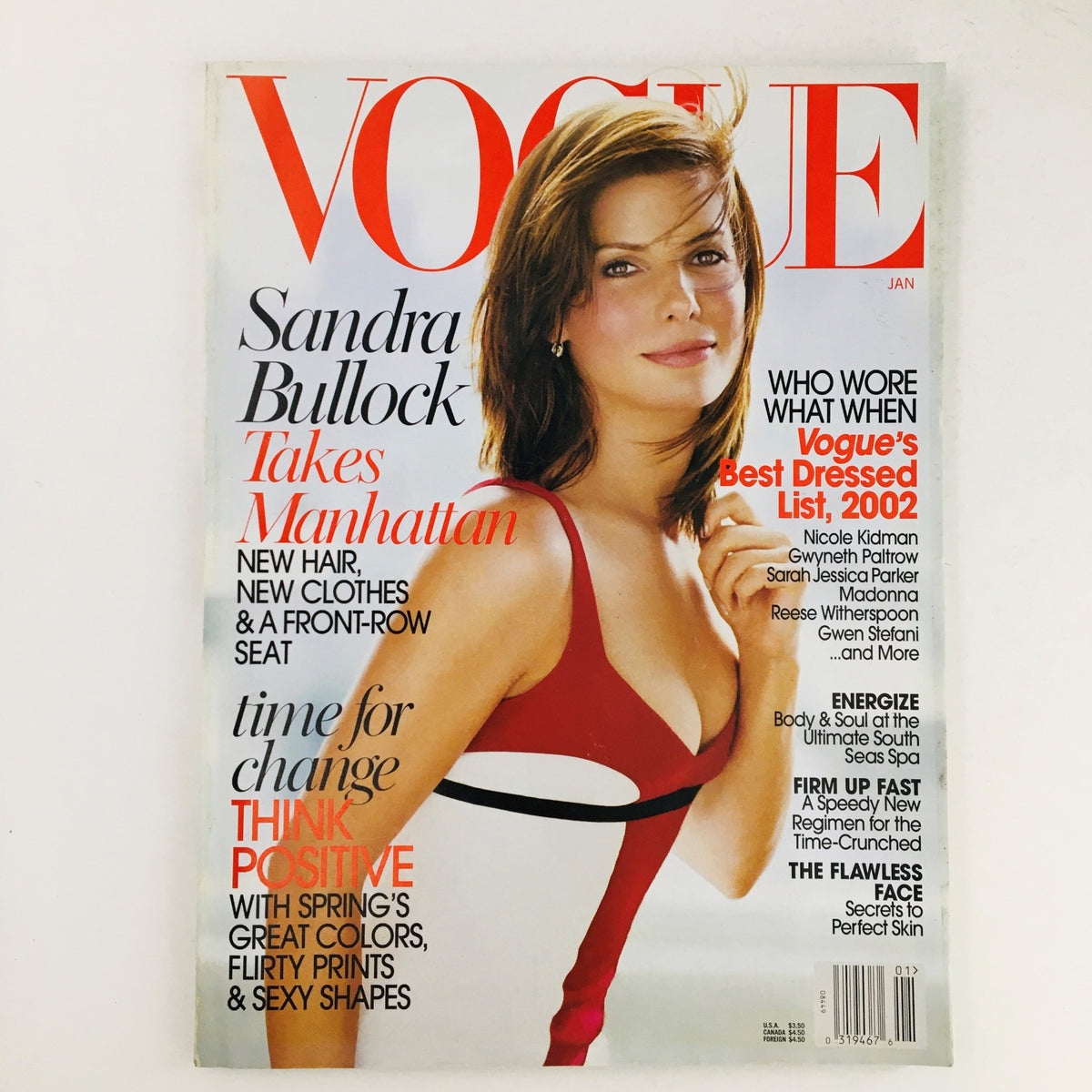 Vogue Magazine January 2003 featuring American Actress Sandra Bullock on the cover, showcasing her striking beauty and timeless fashion in a red and white dress.